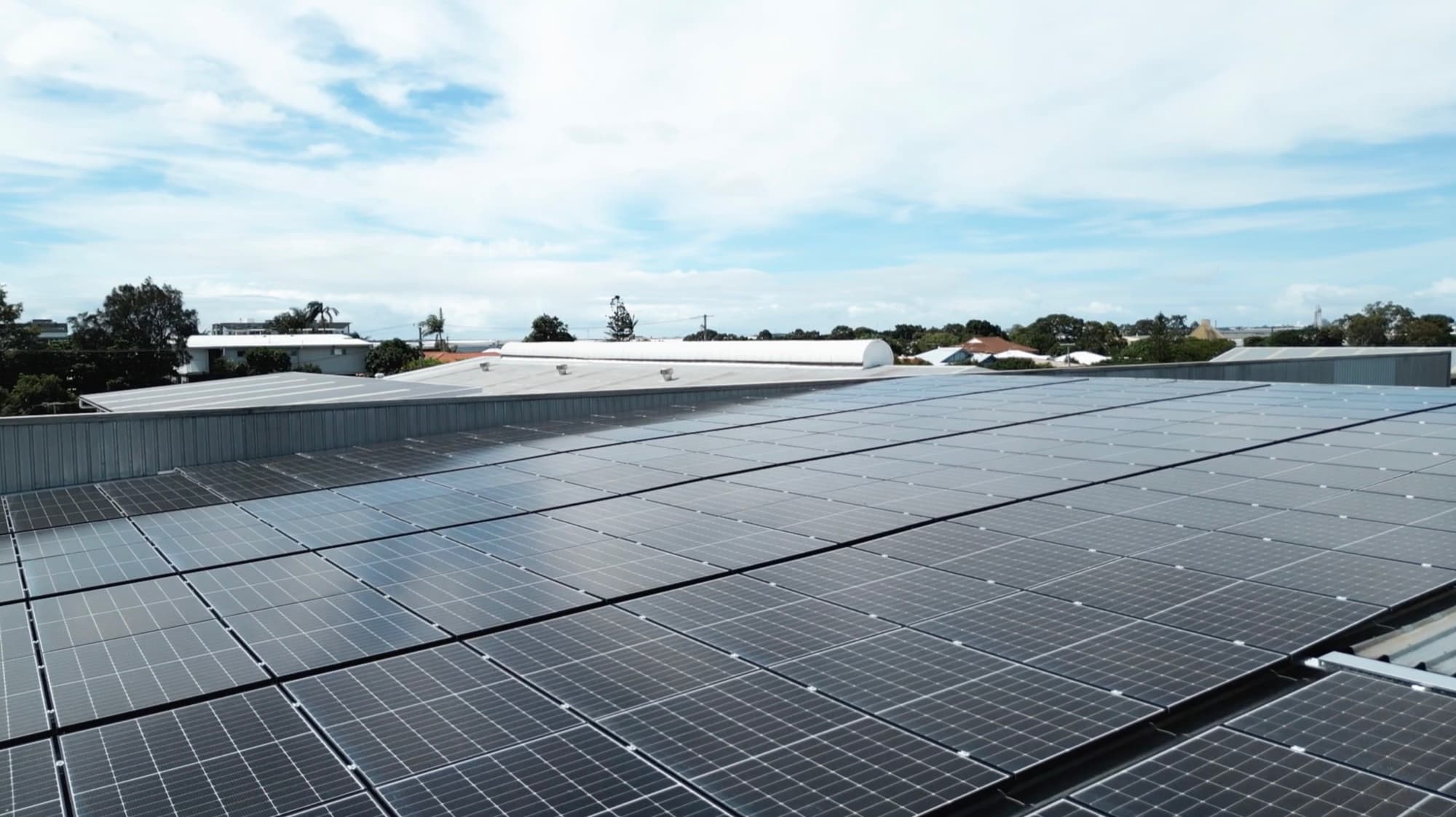 Large commercial rooftop solar array across a warehouse roof